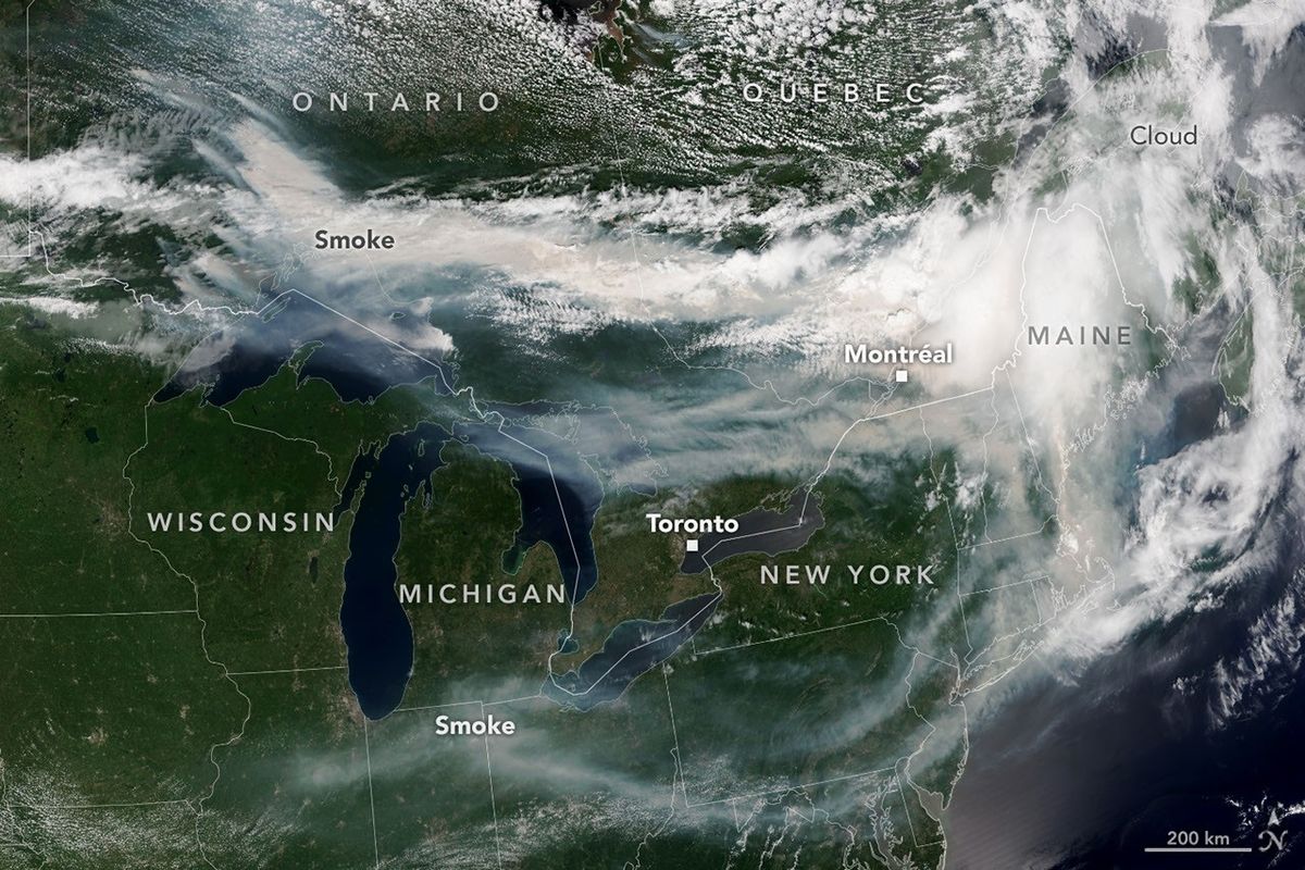 A map of Canada showing white smoke from wildfires.