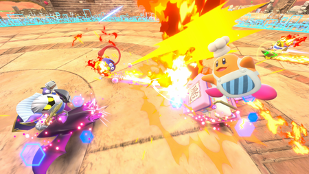 Racers ride over a stone paved corner in Kirby Air Riders, while Chef Kawasaki blasts Gooey and Meta-Knight drifts to the side