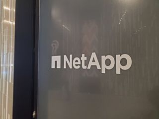 NetApp company logo embossed on a wall at an office building