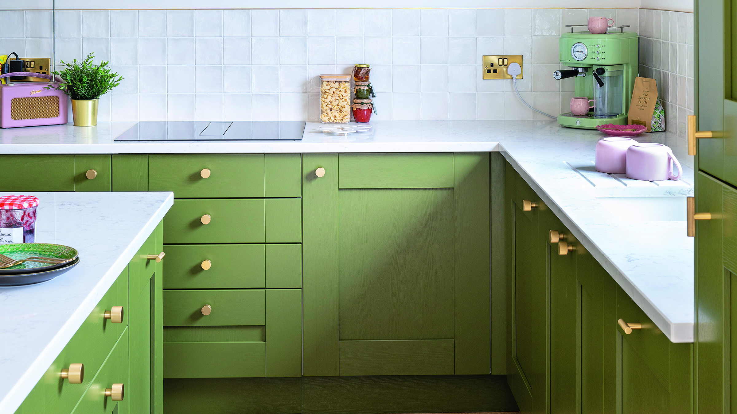 Green kitchen with island and white worktops