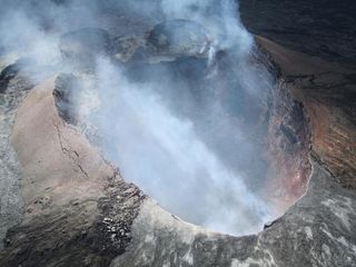 Fume from Pu`u `? `? has diminished enough to see a portion of the rubble-filled crater floor.