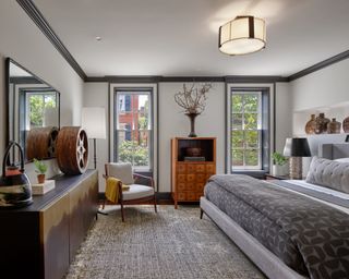 gray bedroom with light gray walls, dark gray trim and gray patterned bedding