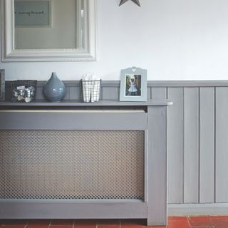 grey panelled hallway with matching radiator cover
