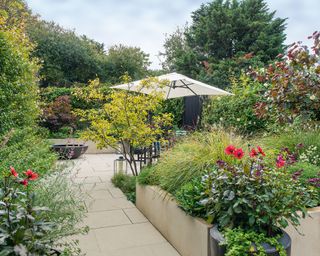 secluded garden seating area with large built in beds