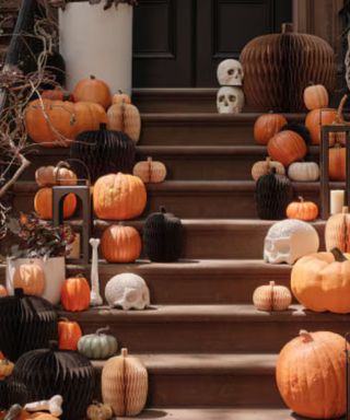 Pumpkins lining the steps of a front porch.