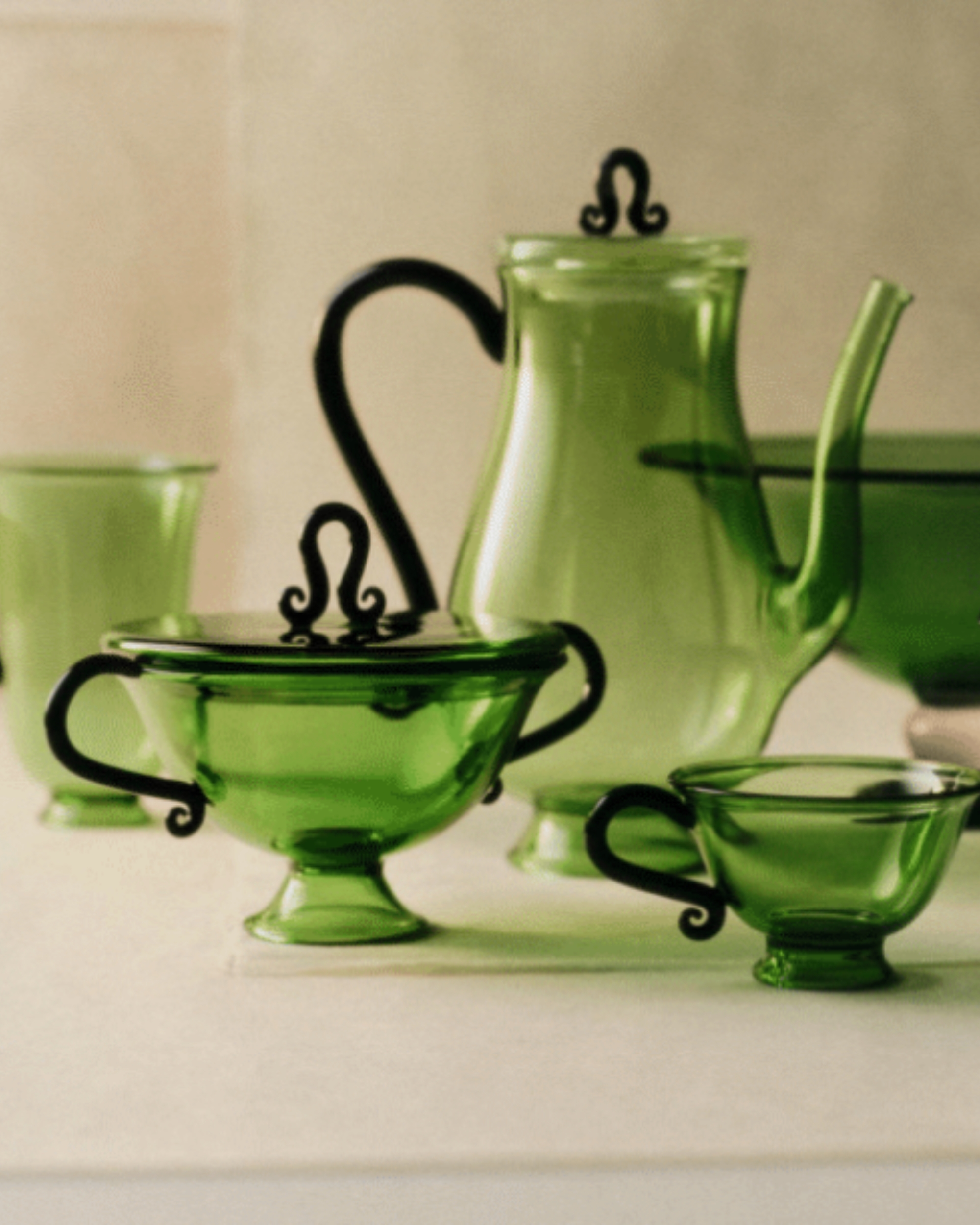 Image of dainty green glassware with black steams.