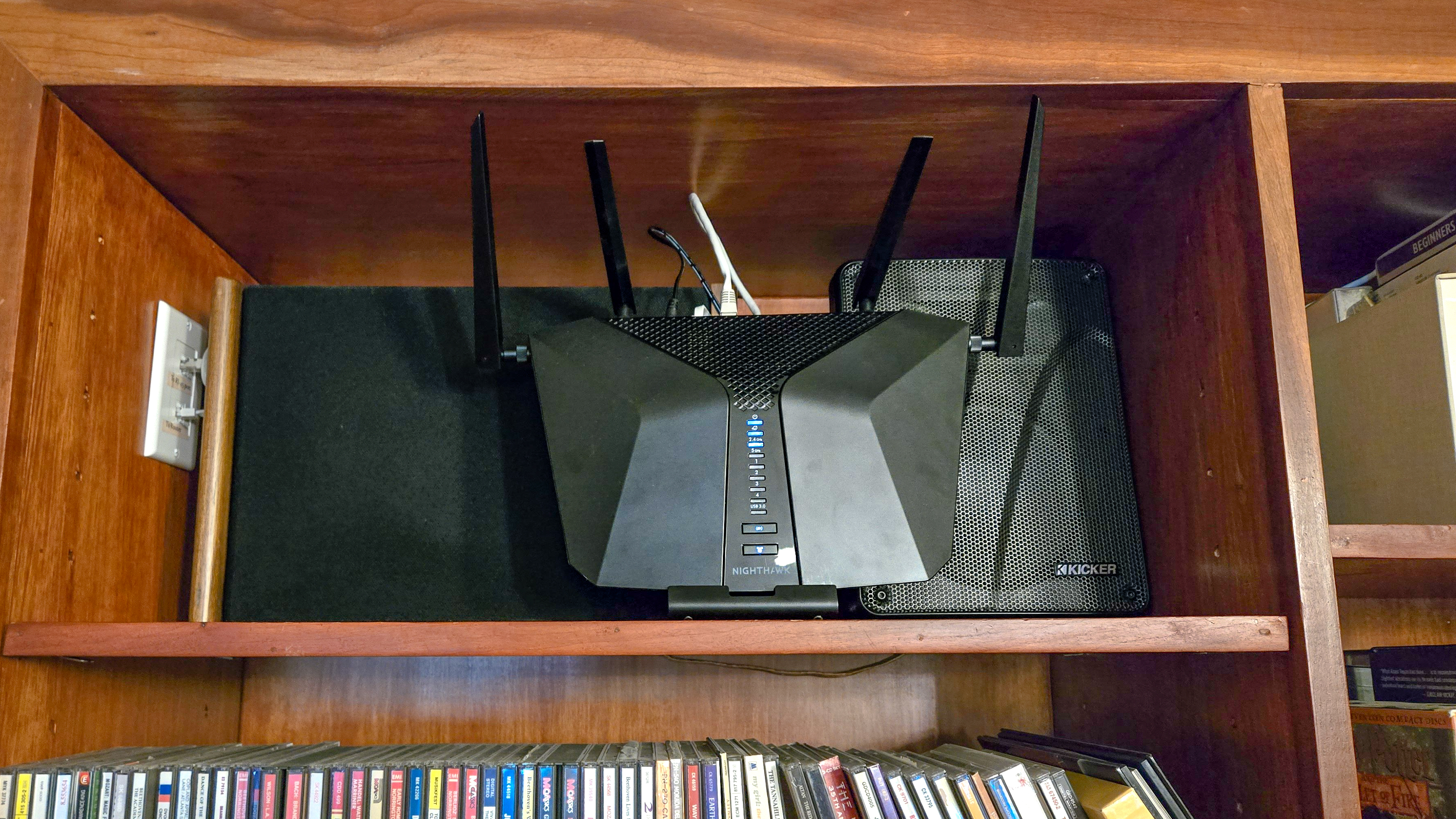 A Wi-Fi router inside a bookshelf causing it to overheat