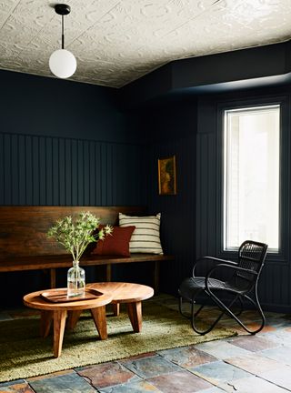 Dark blue living room with white tin tiled ceiling