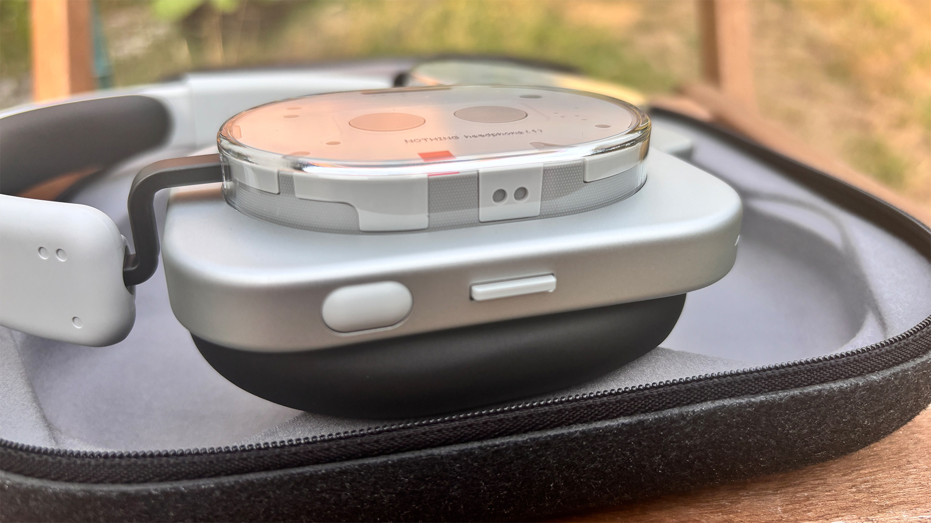 Nothing Headphone (1) wireless headphones lying on case, focus on back of one earcup