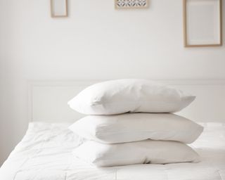 White pillows stacked against a white background