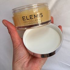 katie holding a tub of elemis cleansing balm