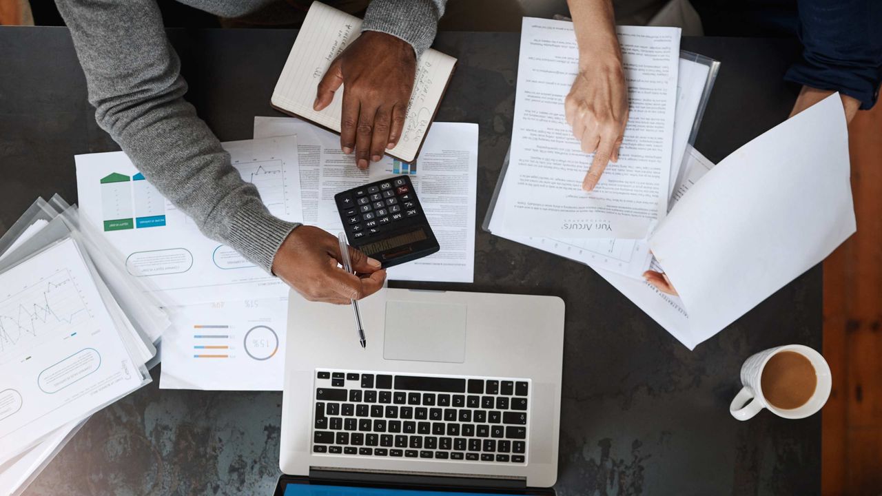 photo of hand of Black man and woman going over financial decisions