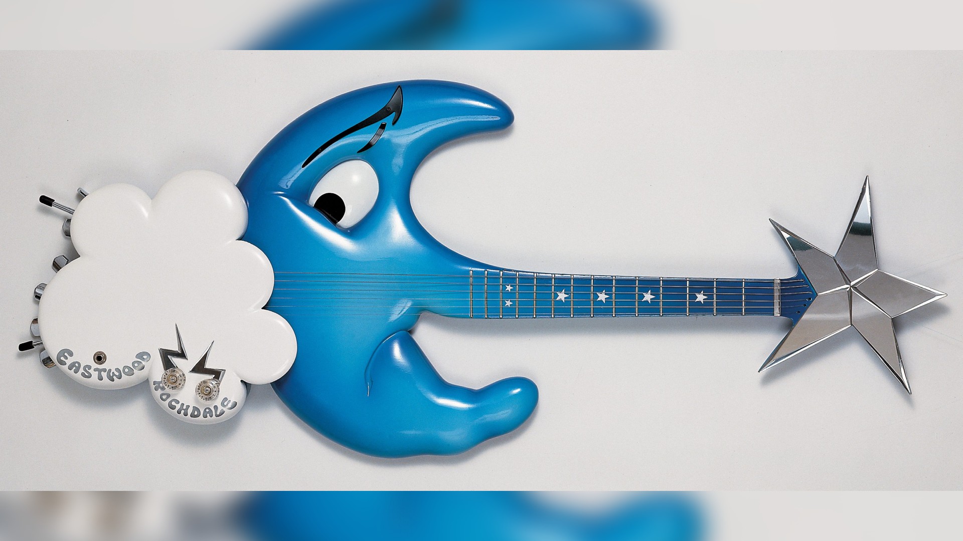 a blue-colored guitar shaped like a moon