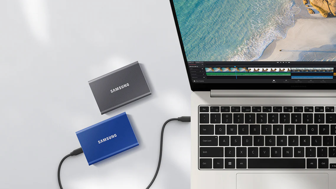 Pair of Samsung T7hard drive, one connected to an Apple laptop