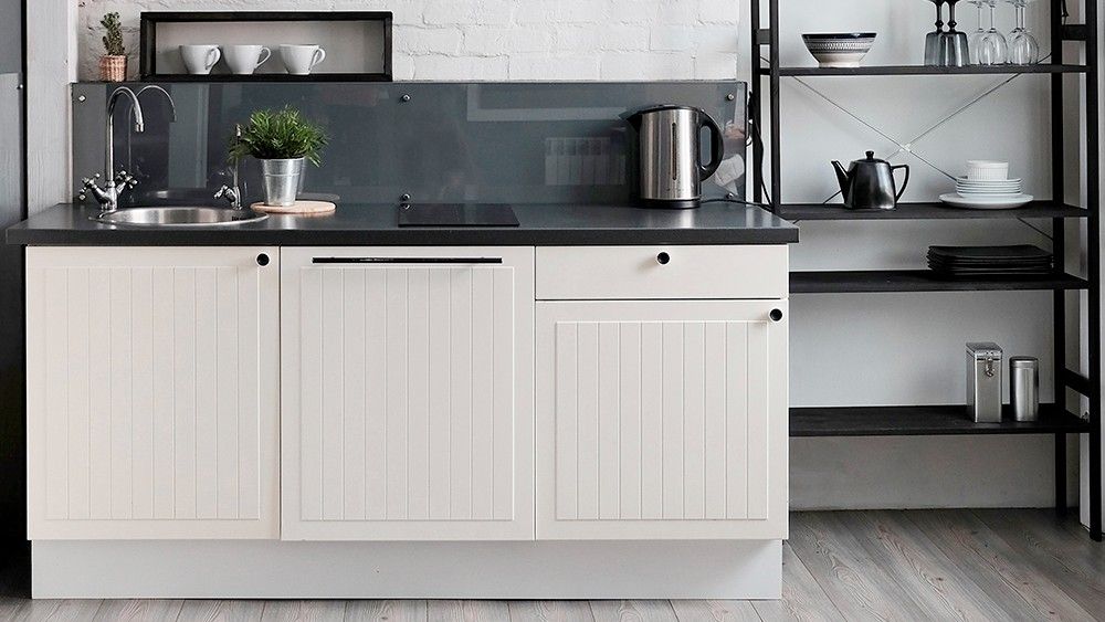 Kitchen with white walls and wooden flooring