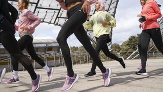 Women running in Adidas UltraBoost 22 running shoes