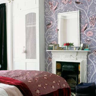 bedroom with fire place and wallpaper