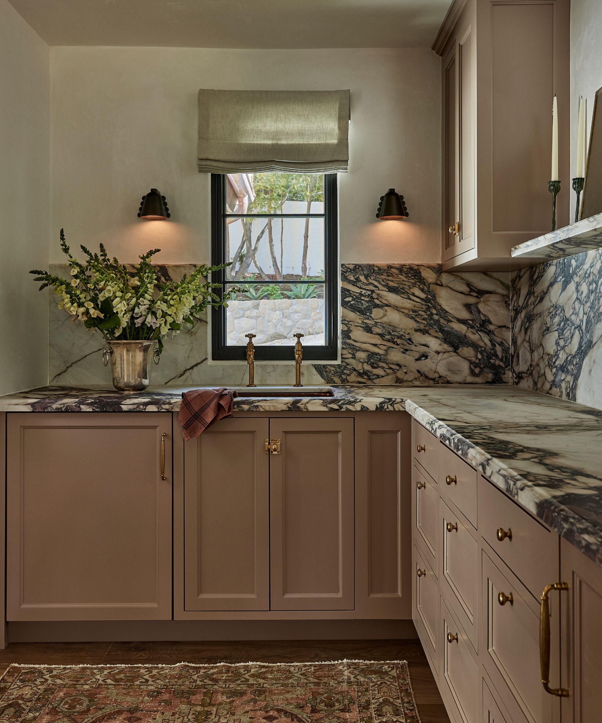 a home bar painted in Farrow &amp;amp; Ball's Dead Salmon with statement marble counter and backsplash