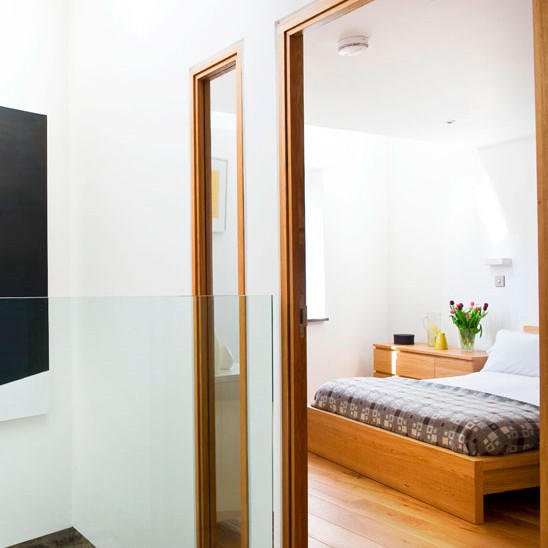 hallway bedroom with wooden bed and flooring