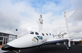 A full-size replica of the Virgin Galactic Spaceship Two sits at the Farnborough International Airshow, Hampshire, England. The image was taken July 9, 2012.