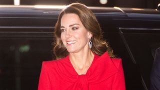 Kate Middleton wearing a red dress attends the "Together at Christmas" community carol service on December 08, 2021 i