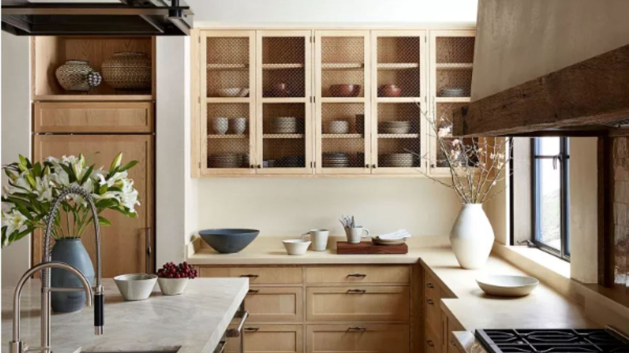 A light wood kitchen with marble counter tops