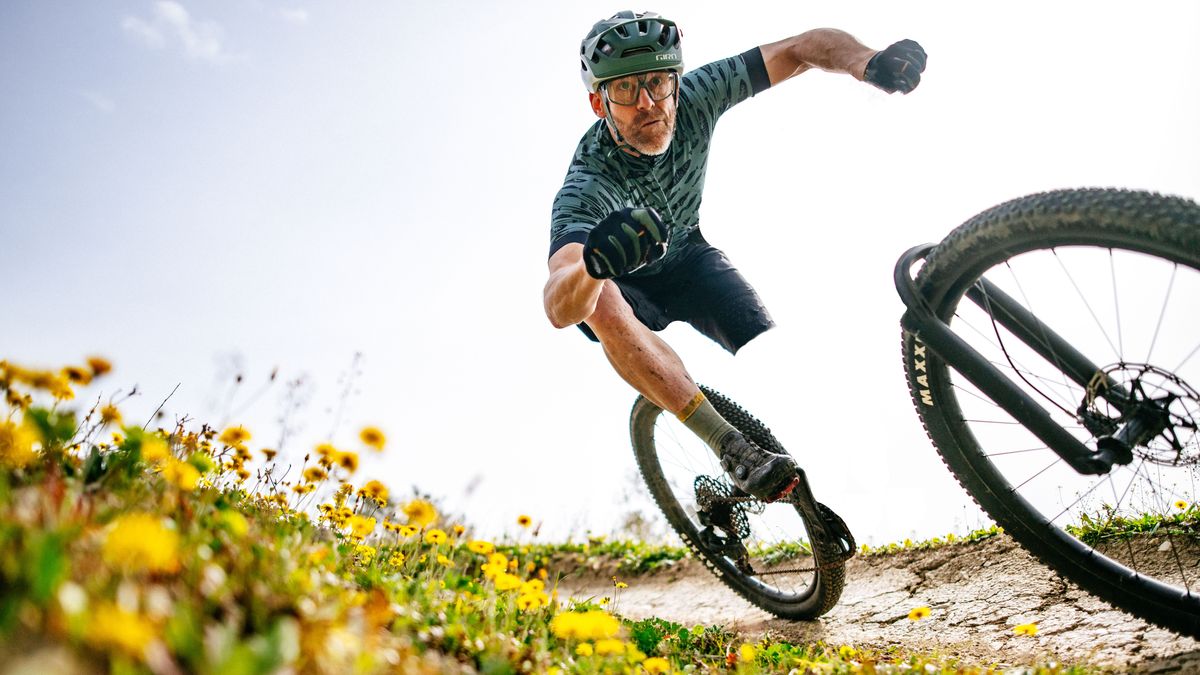 A man riding a bike, but the bike has been edited out