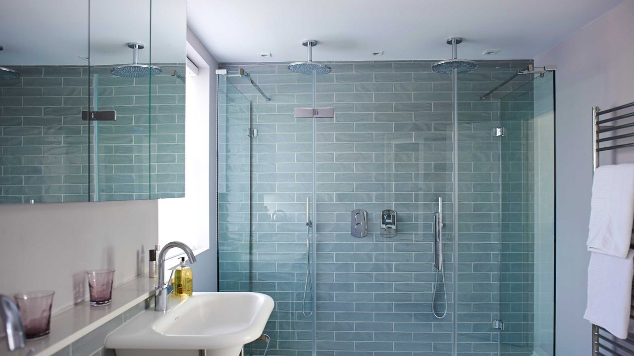 blue tiled bathroom with double shower