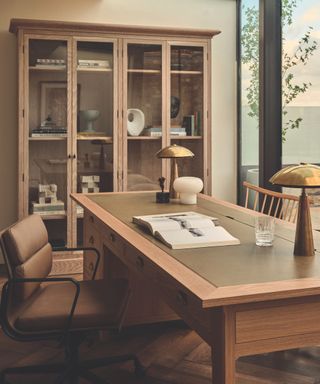 desk with glass fronted cabinet in background