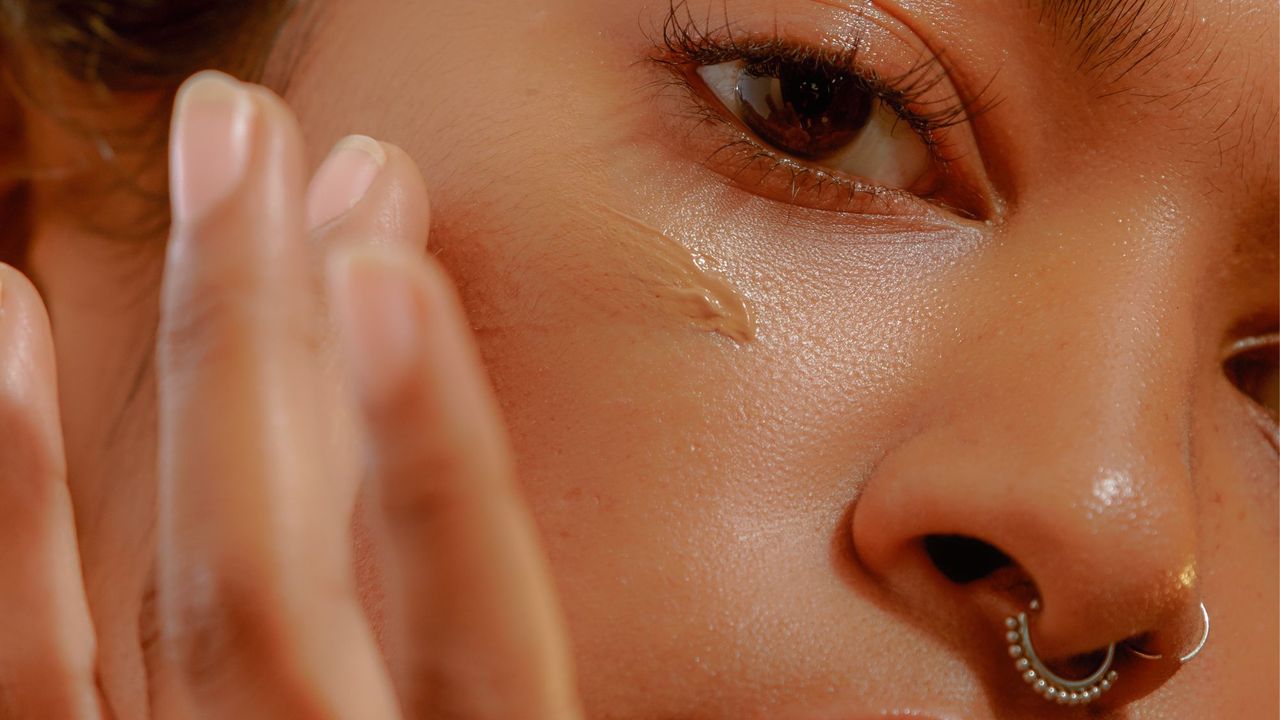 Woman applying foundation for dry skin