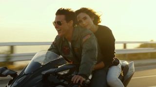 Tom Cruise and Jennifr Connolly on a motorcycle in Top Gun Maverick