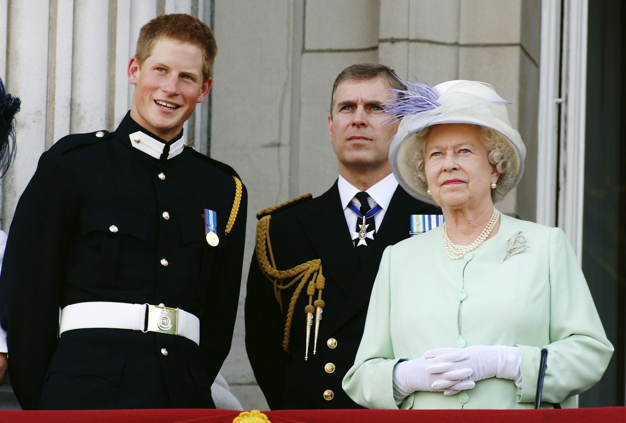 LONDON - JULY 10: Prince Harry wearing his Sandhurst army uniform, Prince Andrew the Duke of York and HM Queen Elizabeth ll watch the flypast over The Mall of British and US World War II aircraft from the Buckingham Palace balcony on National Commemoration Day July 10, 2005 in London. Poppies were dropped from the Lancaster Bomber of the Battle Of Britain Memorial Flight as part of the flypast. (Photo by Anwar Hussein/Getty Images)