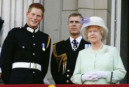 LONDON - JULY 10: Prince Harry wearing his Sandhurst army uniform, Prince Andrew the Duke of York and HM Queen Elizabeth ll watch the flypast over The Mall of British and US World War II aircraft from the Buckingham Palace balcony on National Commemoration Day July 10, 2005 in London. Poppies were dropped from the Lancaster Bomber of the Battle Of Britain Memorial Flight as part of the flypast. (Photo by Anwar Hussein/Getty Images)