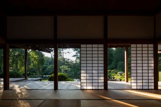 Interior of Shofuso Japanese House and view of the decking, pond and greenery outside