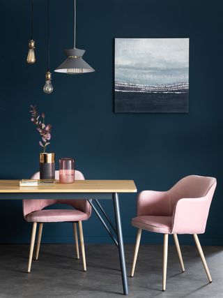 Maisons du monde pink chairs at kitchen table with blue wall