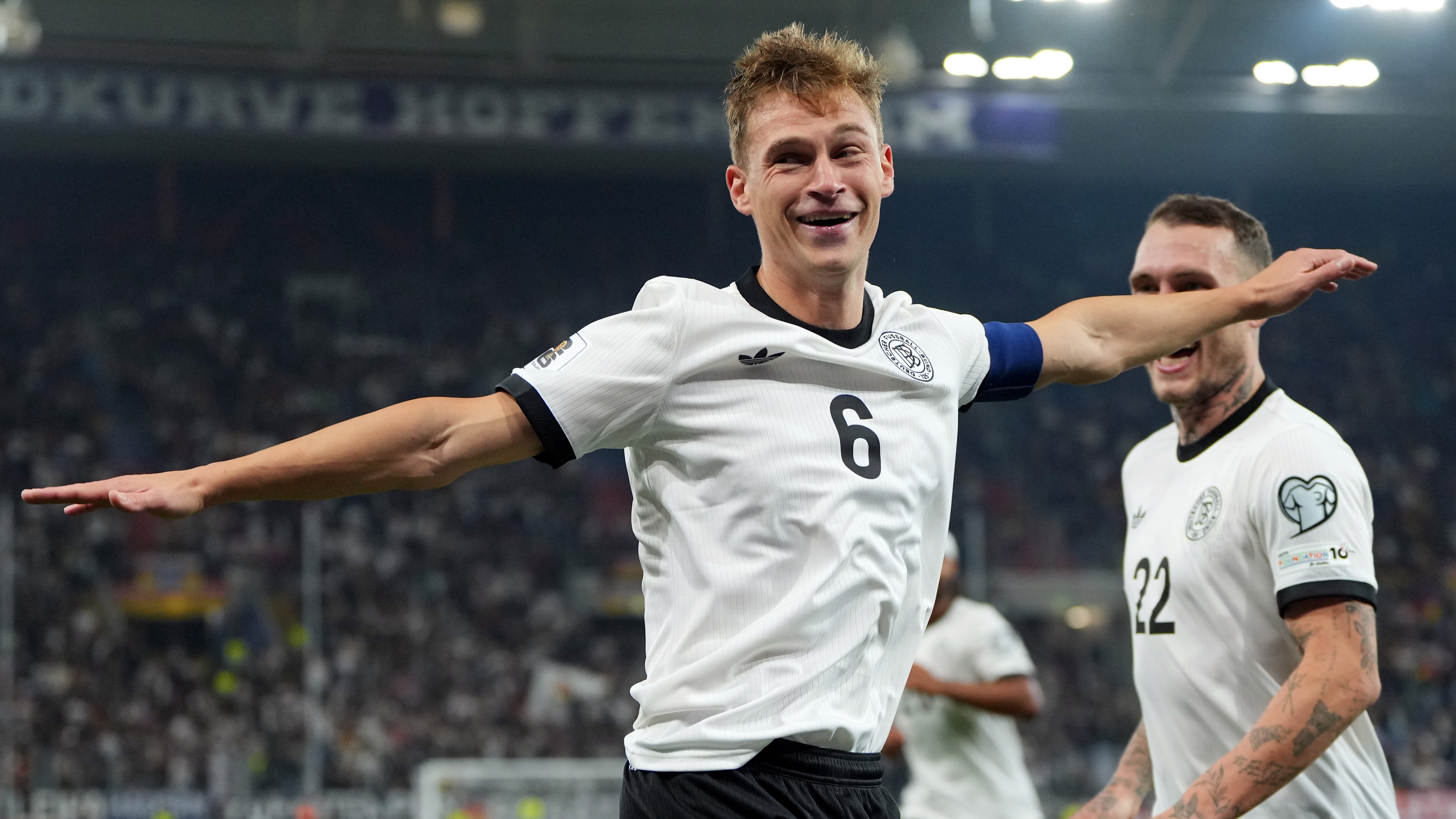 Joshua Kimmich of Germany celebrates scoring his team's fourth goal with teammate David Raum during the FIFA World Cup 2026 Qualifier match between Germany and Luxembourg at PreZero-Arena on October 10, 2025 in Sinsheim, Germany. 