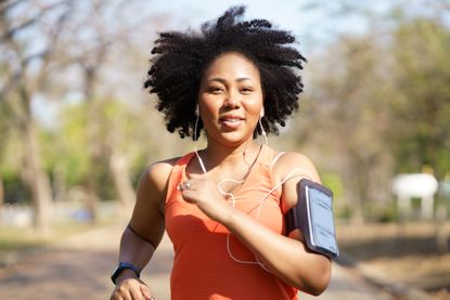 Young woman running exercise wearing heartbeat monitoring and smart watch working out how to run faster