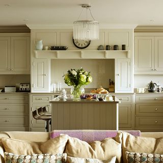 kitchen room with white cabinets and flower in vase