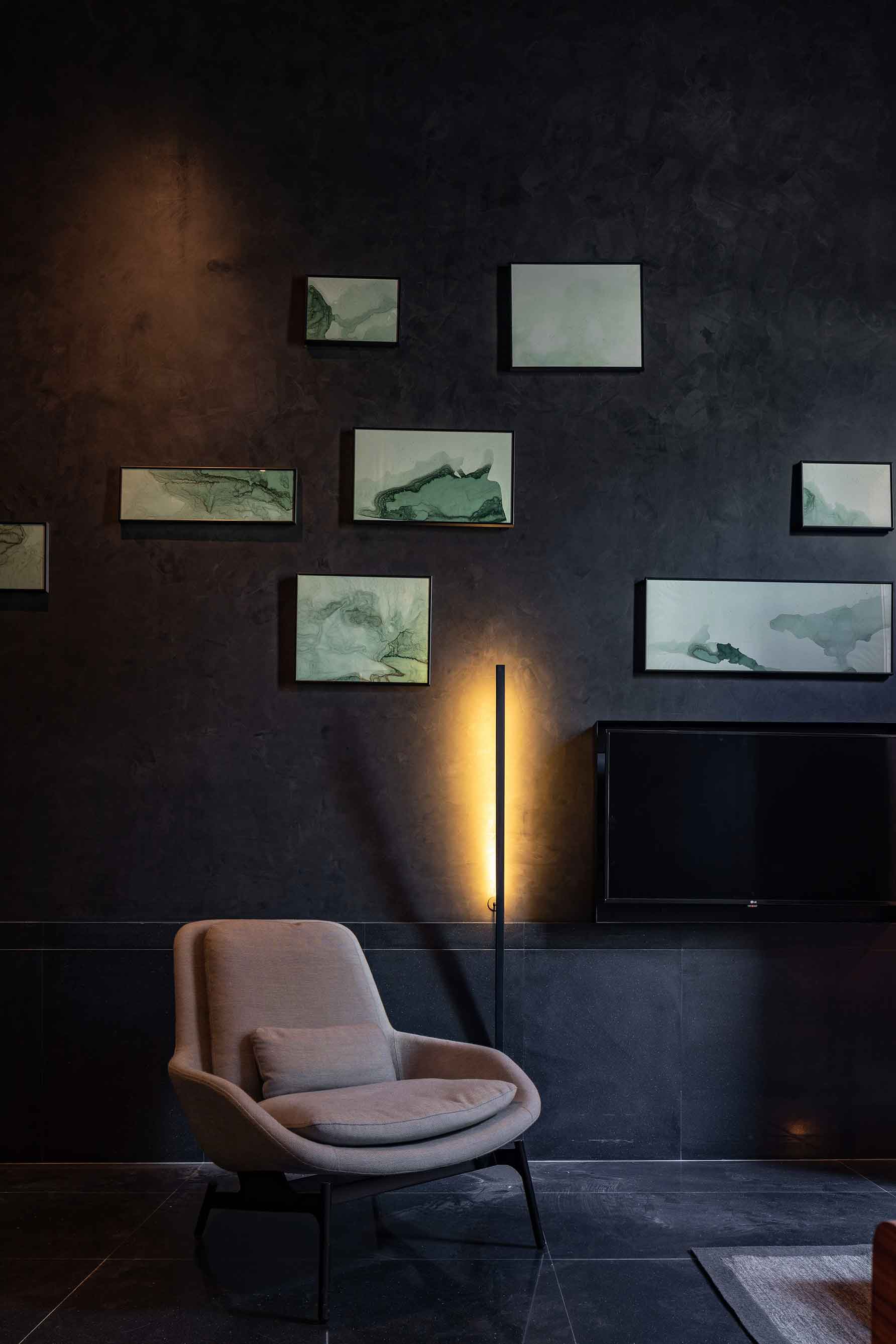Freestanding light fixture next to television, single seater cushioned chair