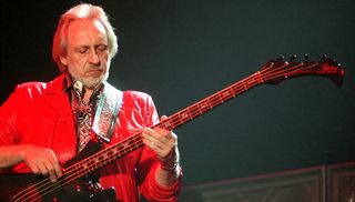 John Entwistle of The Who on stage, performing their album 'Quadrophenia', Ahoy, Rotterdam, 11th May 1997. He plays a Status Graphite Buzzard Bass guitar.