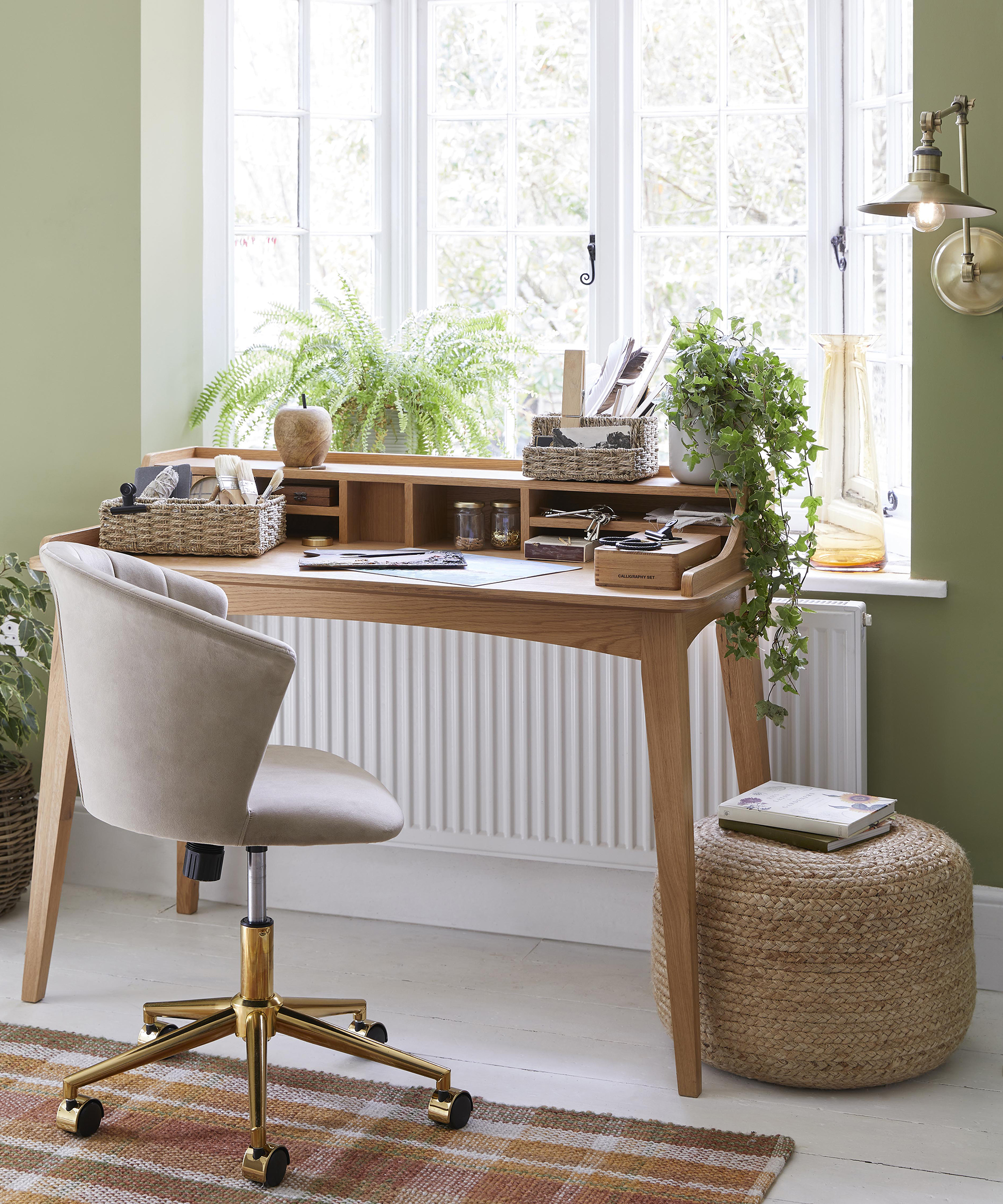 Wooden desk in study area with houseplants and footstool by Dunelm