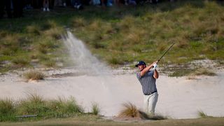 Bryson DeChambeau takes a bunker shot in the final round of the US Open