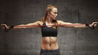 Do resistance bands work? image shows woman using resistance band