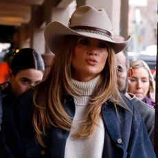 Jennifer Lopez is seen on December 29, 2024 in Aspen, Colorado wearing a cowboy hat, navy blue barn jacket, oat-colored turtleneck sweater, barrel jeans, and lug-sole tan boots.