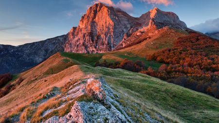 A large mountain range in the sunset