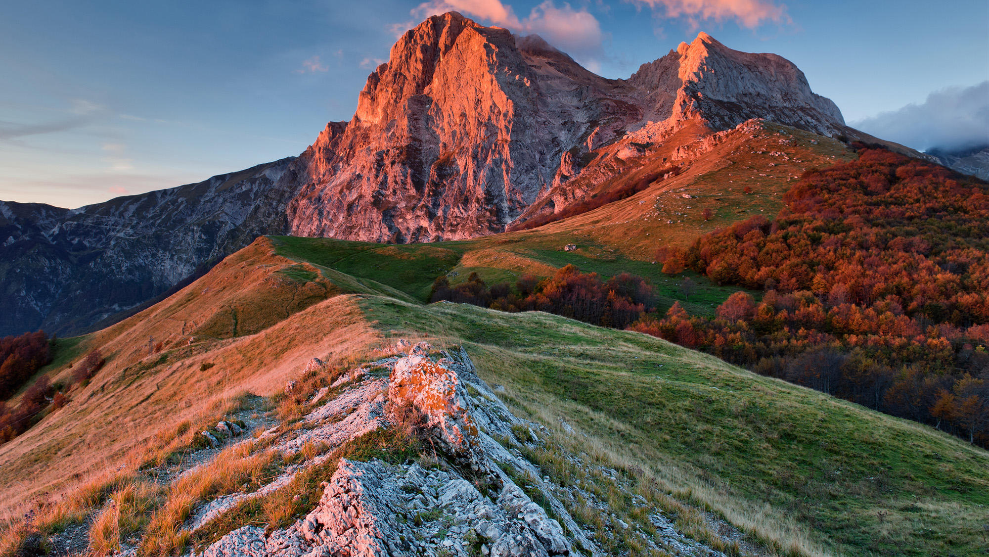 A large mountain range in the sunset