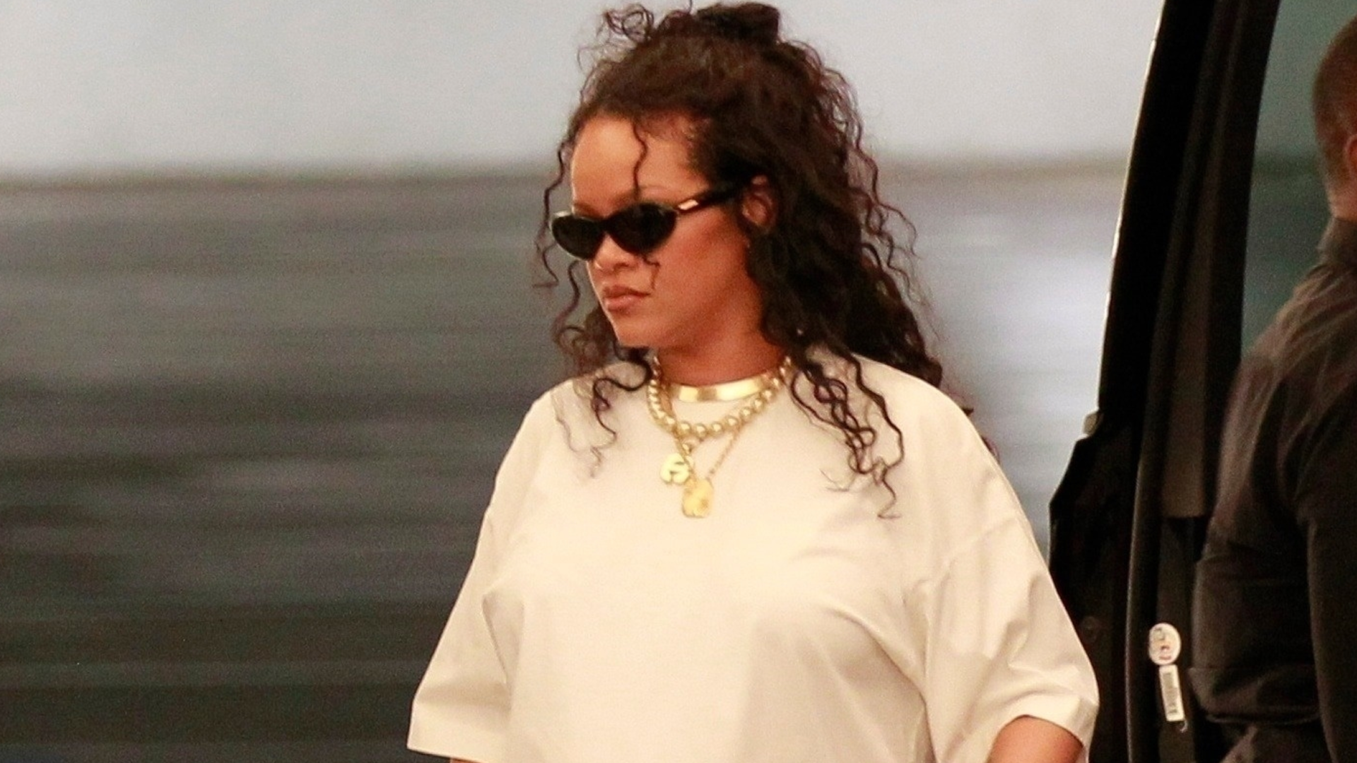 Rihanna paired a white T-shirt with Puma x Fenty flip-flops and a rare Fendi Baguette