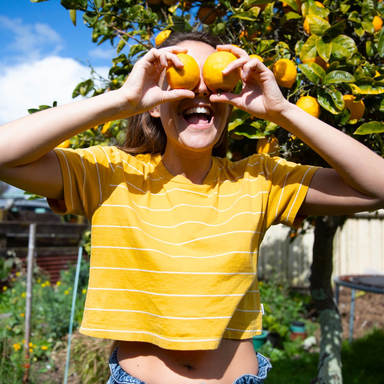 woman holding lemons up to her eyes 