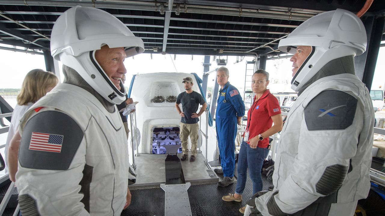 NASA astronauts Doug Hurley, left, and Bob Behnken work with teams from NASA and SpaceX to rehearse crew extraction from SpaceX&rsquo;s Crew Dragon, which will be used to carry humans to the International Space Station, on August 13, 2019 at the Trident Basin in Cape Canaveral, Florida. Using the Go Searcher ship SpaceX uses to recover their spacecraft after splashdown and a mock-up of the Crew Dragon, the teams worked through the steps necessary to get NASA astronauts Doug Hurley and Bob Behnken out of the Dragon and back to dry land. Hurley and Behnken will fly to the space station aboard the Crew Dragon for the SpaceX Demo-2 mission.