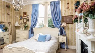 French style bedroom with blue curtains and french bed
